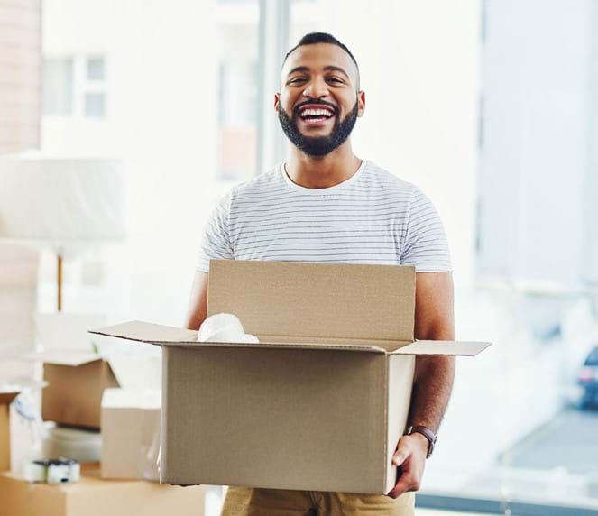 Man moving in with moving box